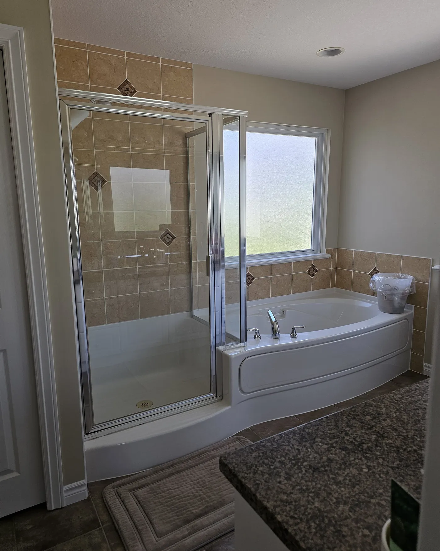 Bathroom renovation in Port Coquitlam by PS Tiling: Tub by the window, before.