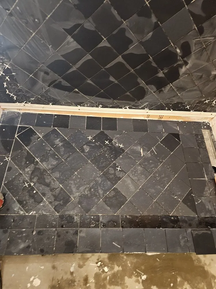 Bathroom renovation by PS Tiling, a black mosaic shower curb being built before the tile goes on, mid-renovation.