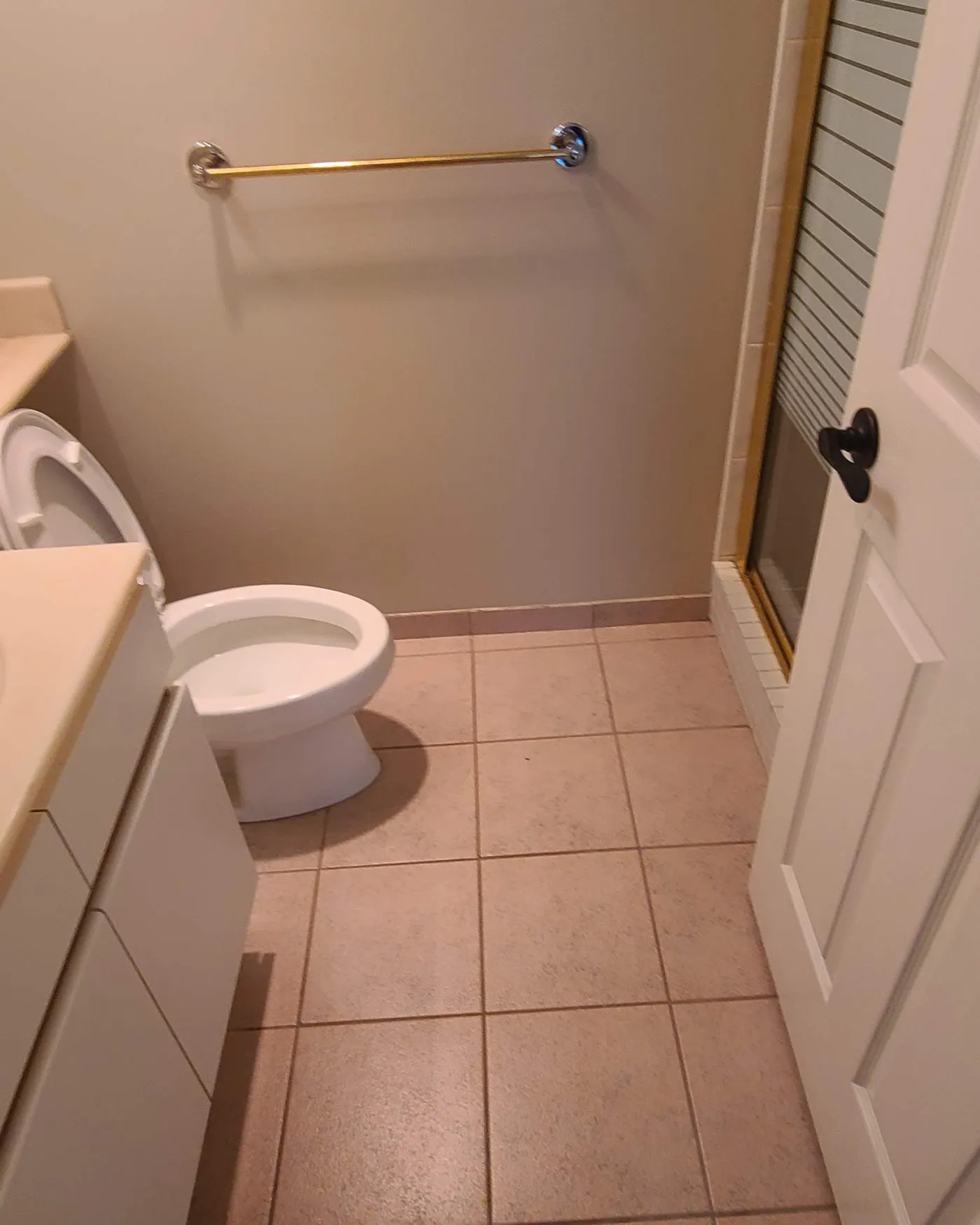 Bathroom renovation in Vancouver by PS Tiling: From the doorway, before.