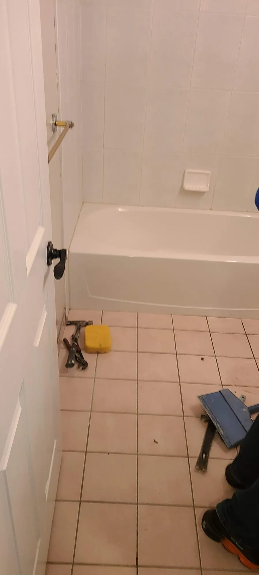 Condo bathroom renovation in Fairview, Vancouver by PS Tiling: old bathtub and square beige floor tile, before.