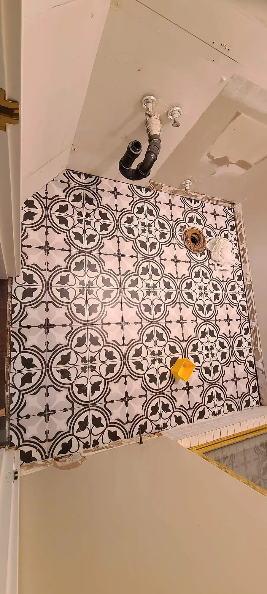 Condo bathroom renovation in Fairview, Vancouver by PS Tiling: patterned floor tile half laid, during tiling.