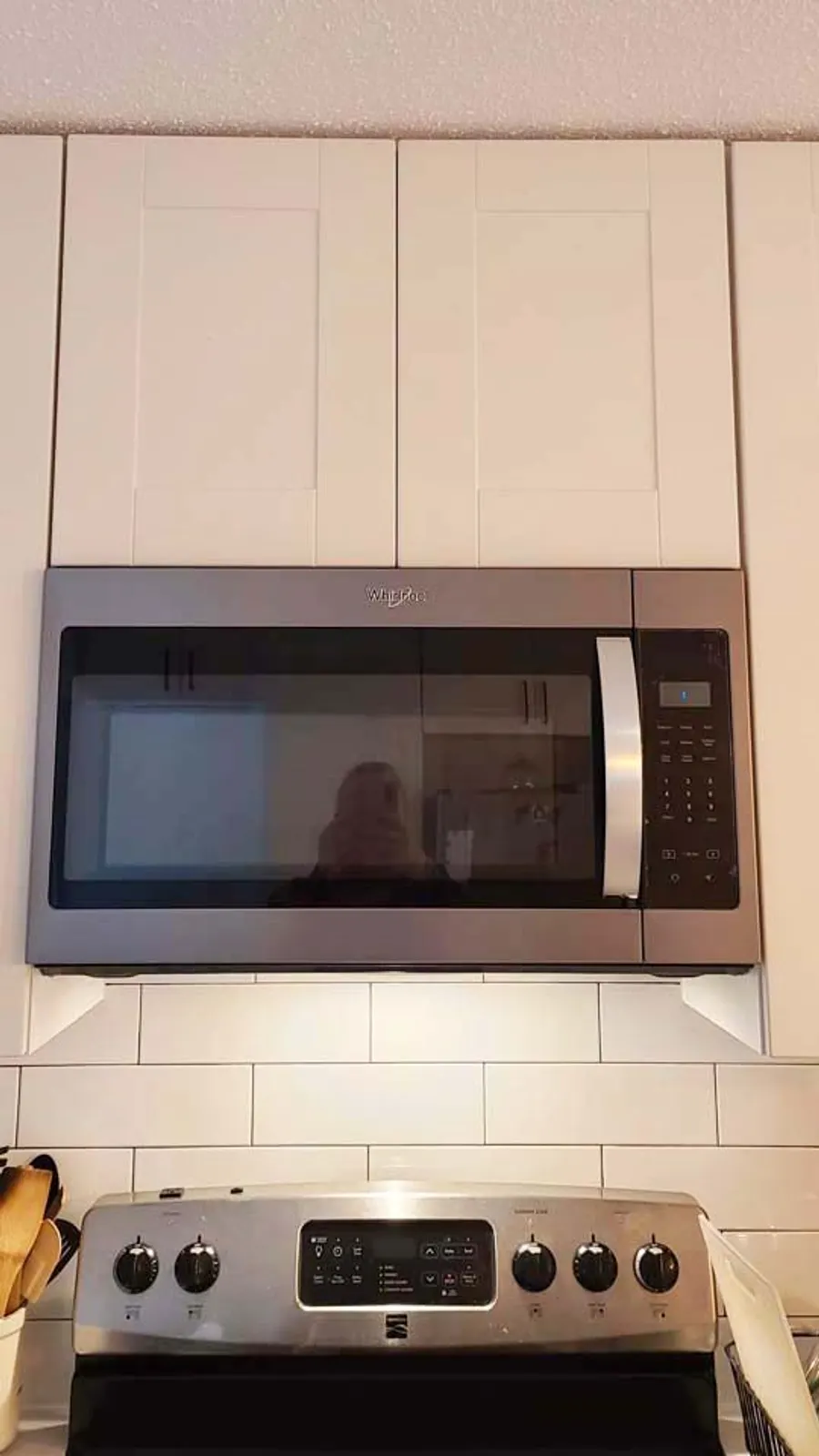 Kitchen renovation in Port Moody by PS Tiling: over-the-range microwave in white cabinets with subway backsplash, finished.