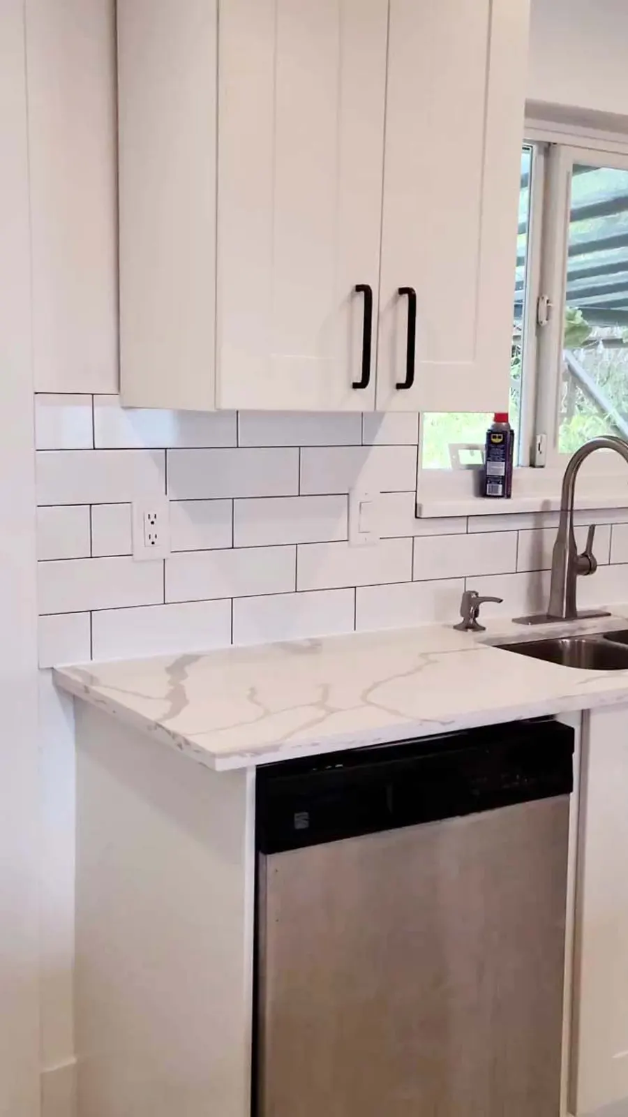 Kitchen renovation in Port Moody by PS Tiling: sink and dishwasher with subway backsplash, detail.