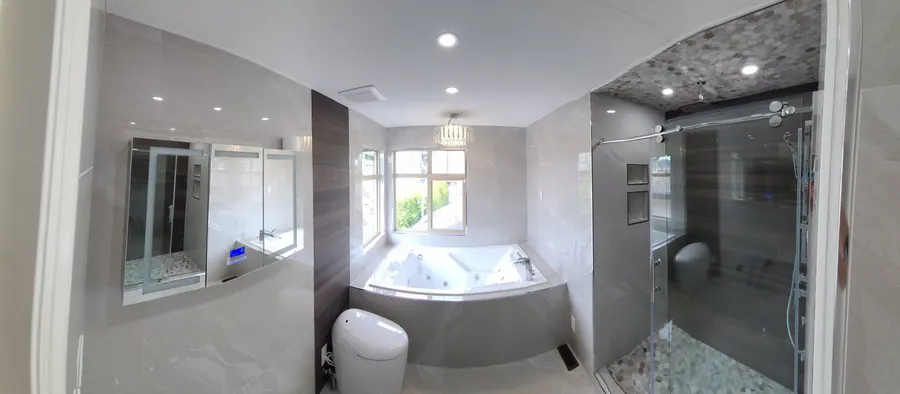 Master bathroom renovation in Burquitlam, Coquitlam by PS Tiling: wide view of the master bathroom with jacuzzi tub, wood-look accent wall and glass shower, finished.
