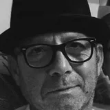 Sasha, owner of PS Tiling, in a black hat and glasses.